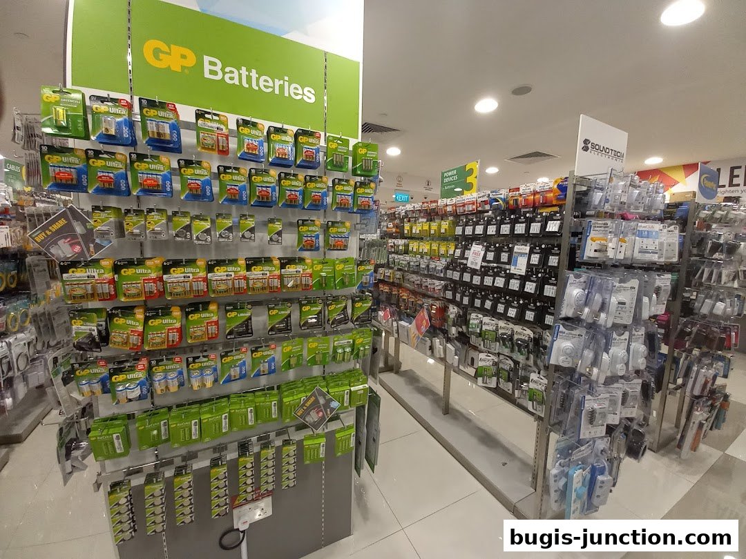 A wide selection of batteries and electronic accessories displayed on shelves in a retail store.