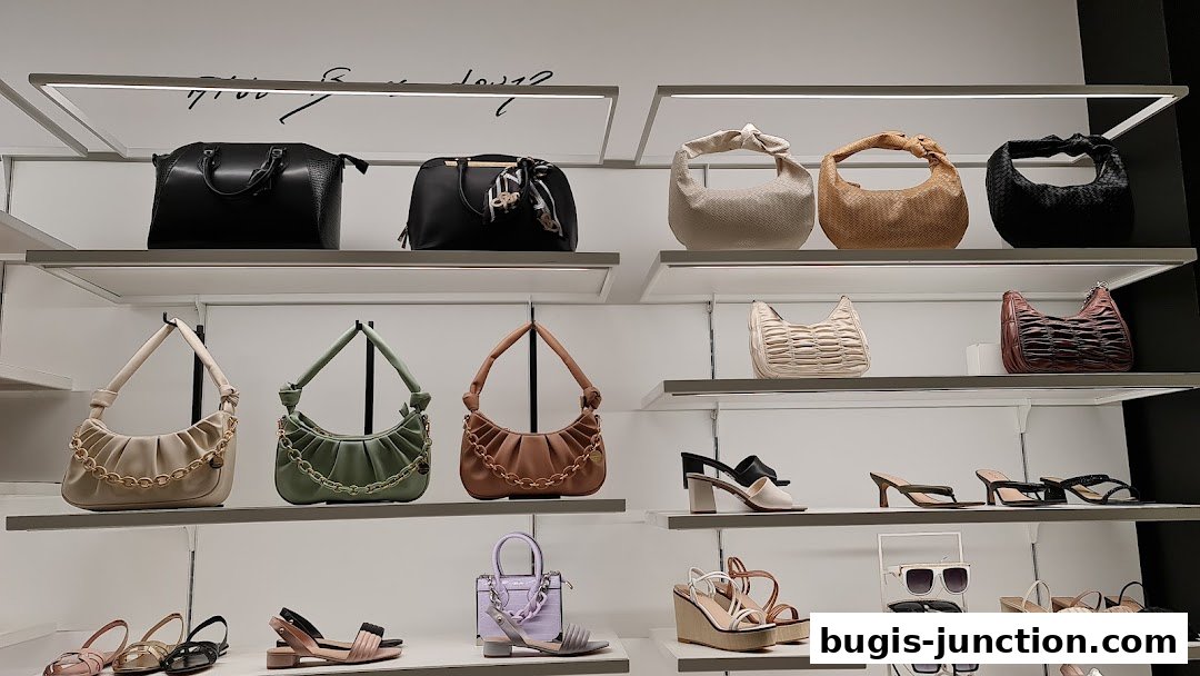 A display of stylish handbags and shoes on shelves in a retail store.