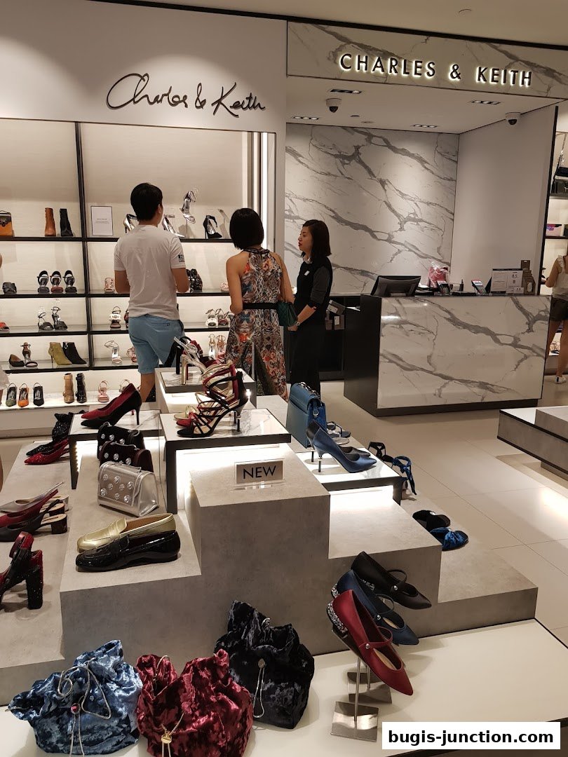 A well-lit Charles & Keith store showcasing a variety of stylish shoes and handbags.