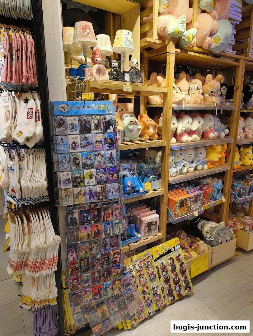 A retail shop interior displaying various merchandise including socks, plush toys, lamps, and collectible cards.