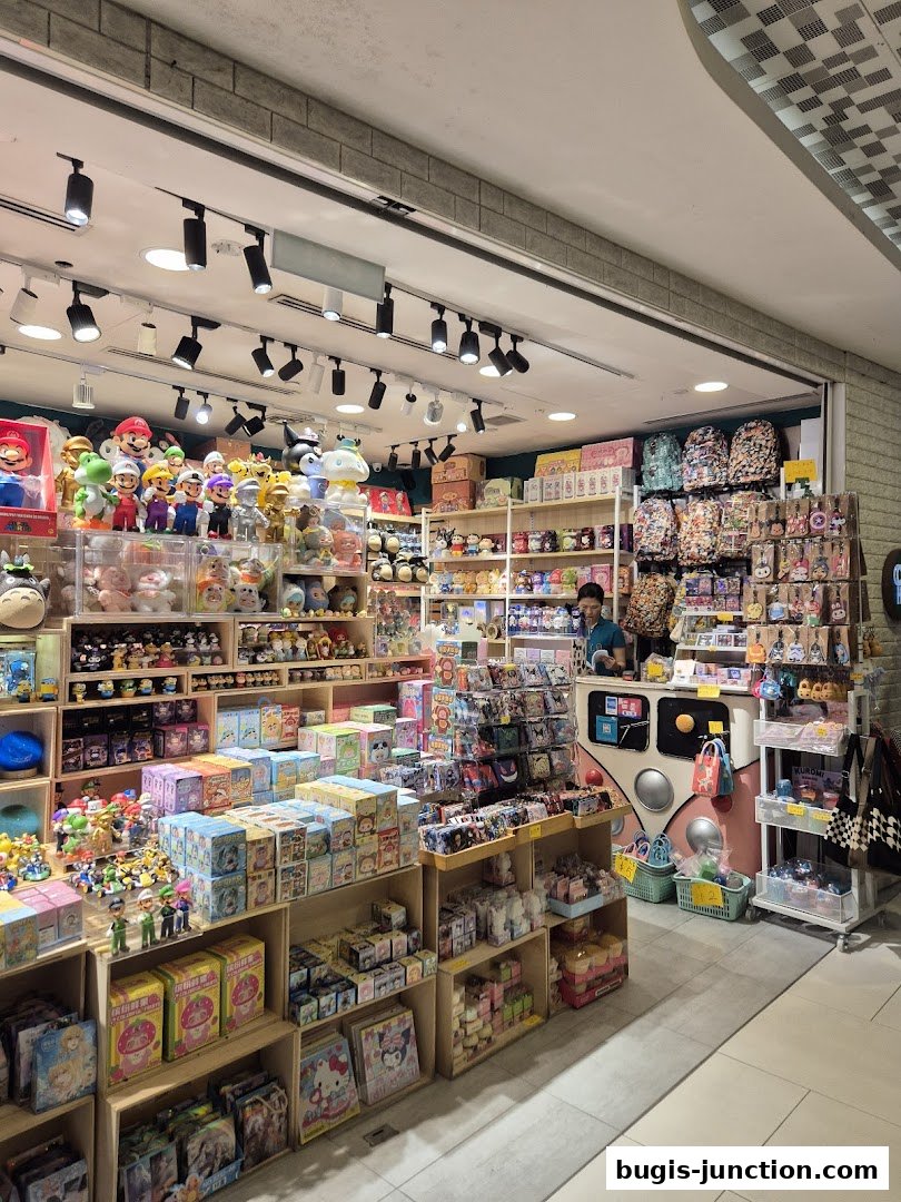 A brightly lit shop interior filled with shelves of anime merchandise, plush toys, and accessories.
