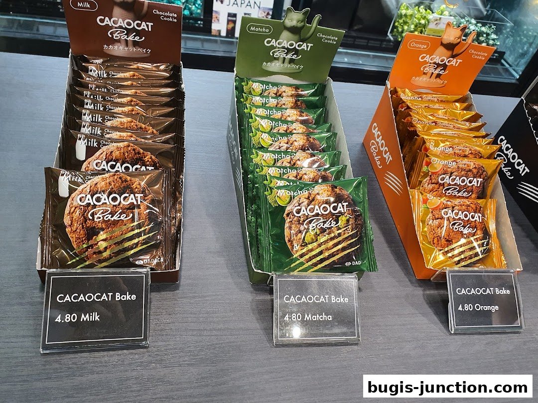 Display of individually wrapped chocolate cookies in milk, matcha, and orange flavors.