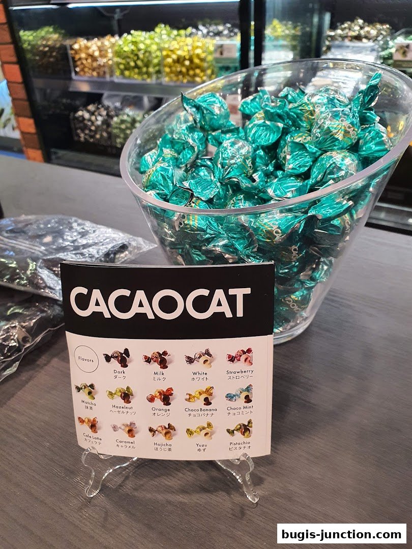 A display of individually wrapped chocolates in teal foil, with a flavor guide.