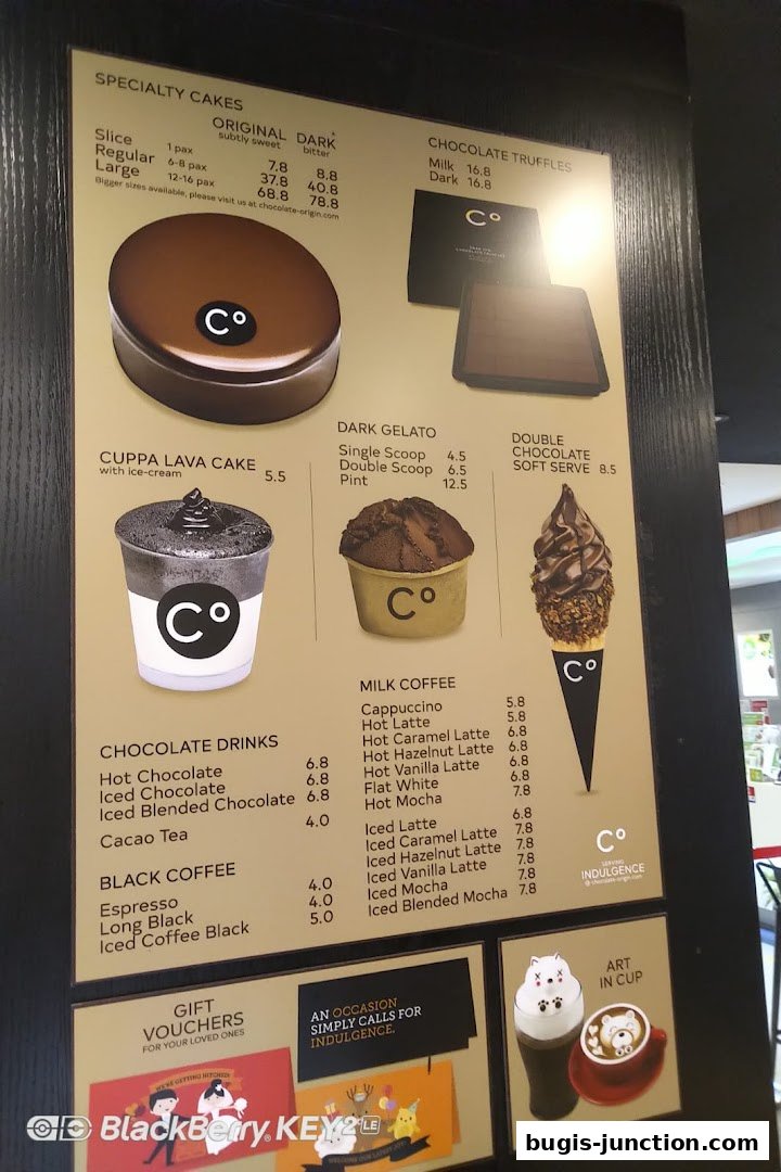 A menu board displaying various chocolate cakes, gelato, drinks, and soft serves from Chocolate Origin.