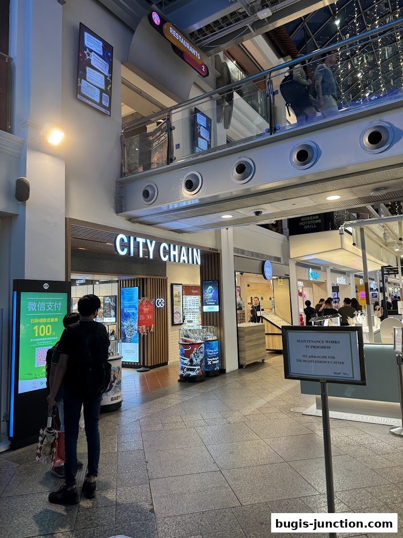The City Chain store entrance with watches displayed and a payment information screen.