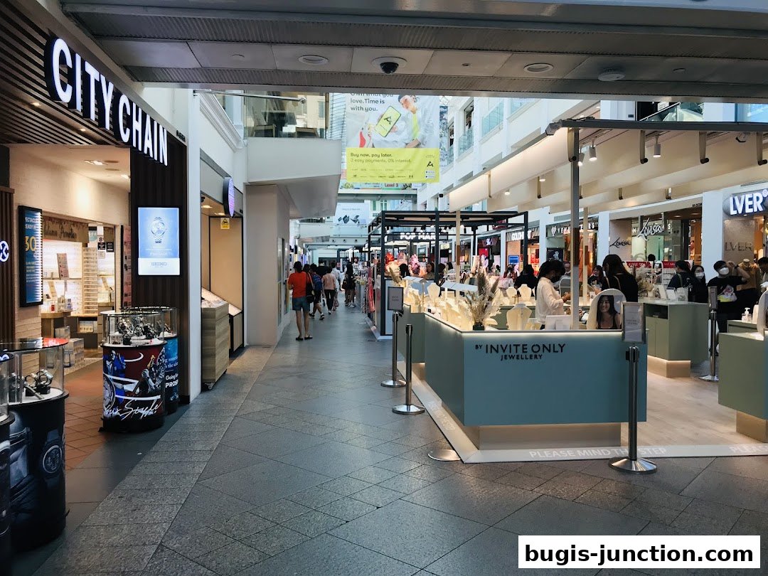The City Chain watch store and other shops in a mall walkway.