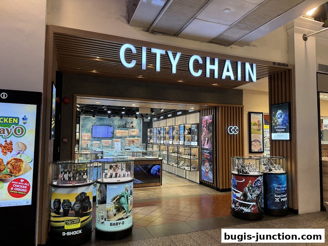 The City Chain watch store features a modern facade with illuminated signage and display cases showcasing watches.
