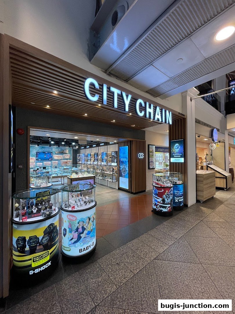 The City Chain watch store features illuminated signage and displays of watches, including G-Shock and Baby-G.