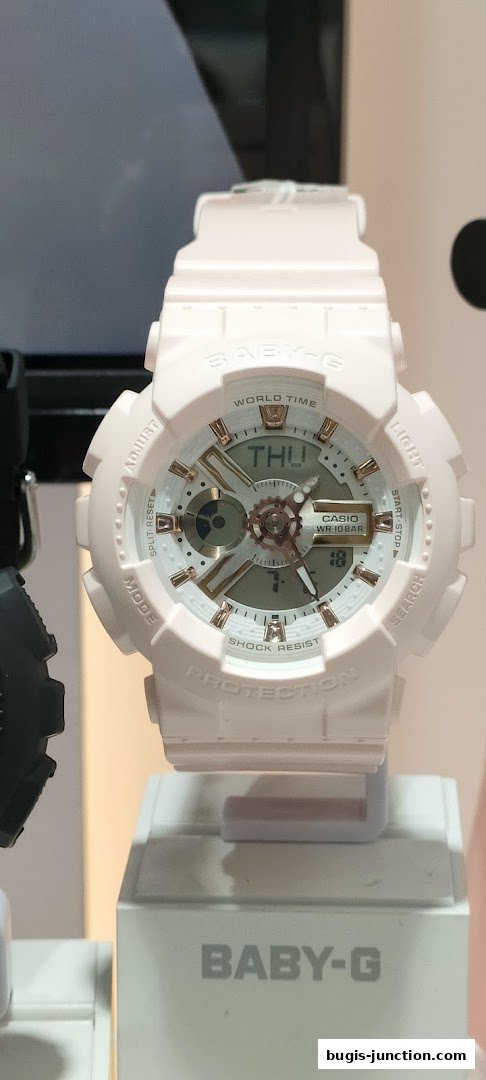 A close-up of a light pink Baby-G watch with a white and rose gold face.