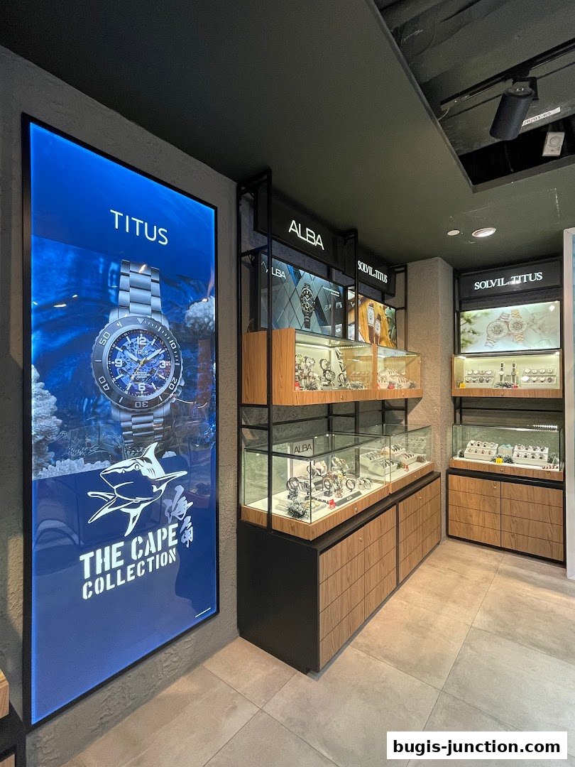 Interior view of a watch store showcasing various brands and collections in display cases.