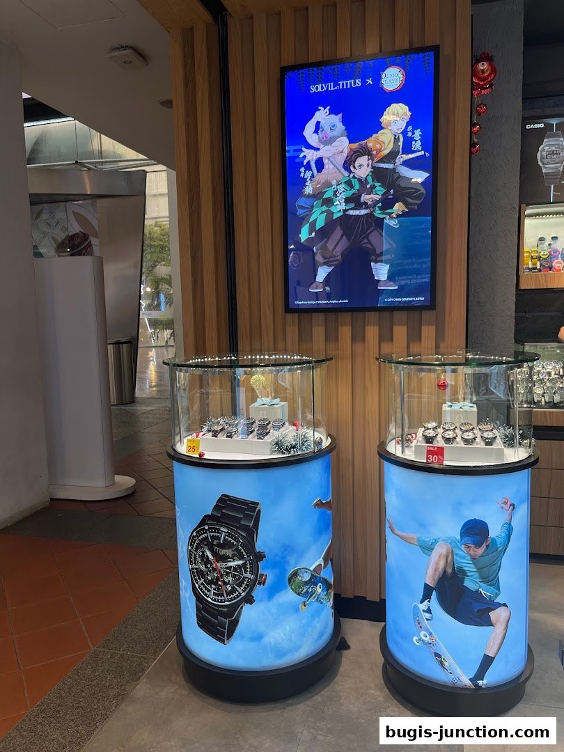 City Chain watch store display featuring anime characters and watches in glass cases.