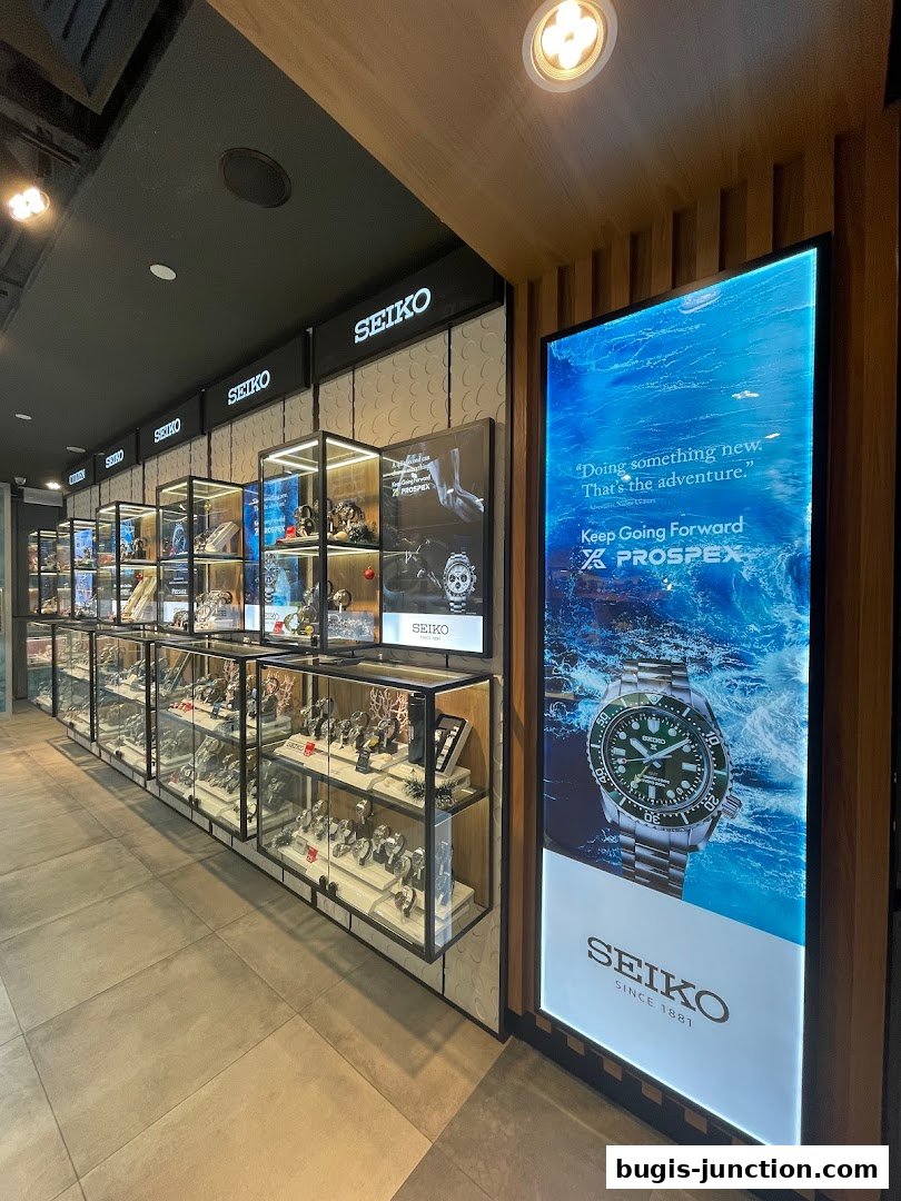 A well-lit Seiko watch store interior with display cases filled with watches and a large advertisement.