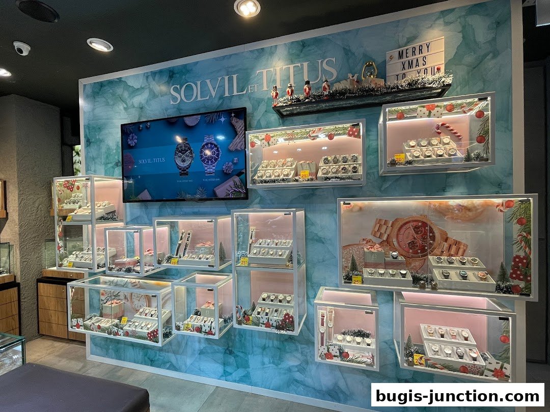 A well-lit display of watches in glass cases, with festive Christmas decorations.
