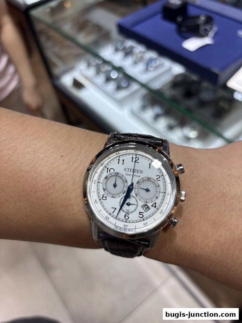 A close-up shot of a Citizen Eco-Drive watch on a person's wrist.