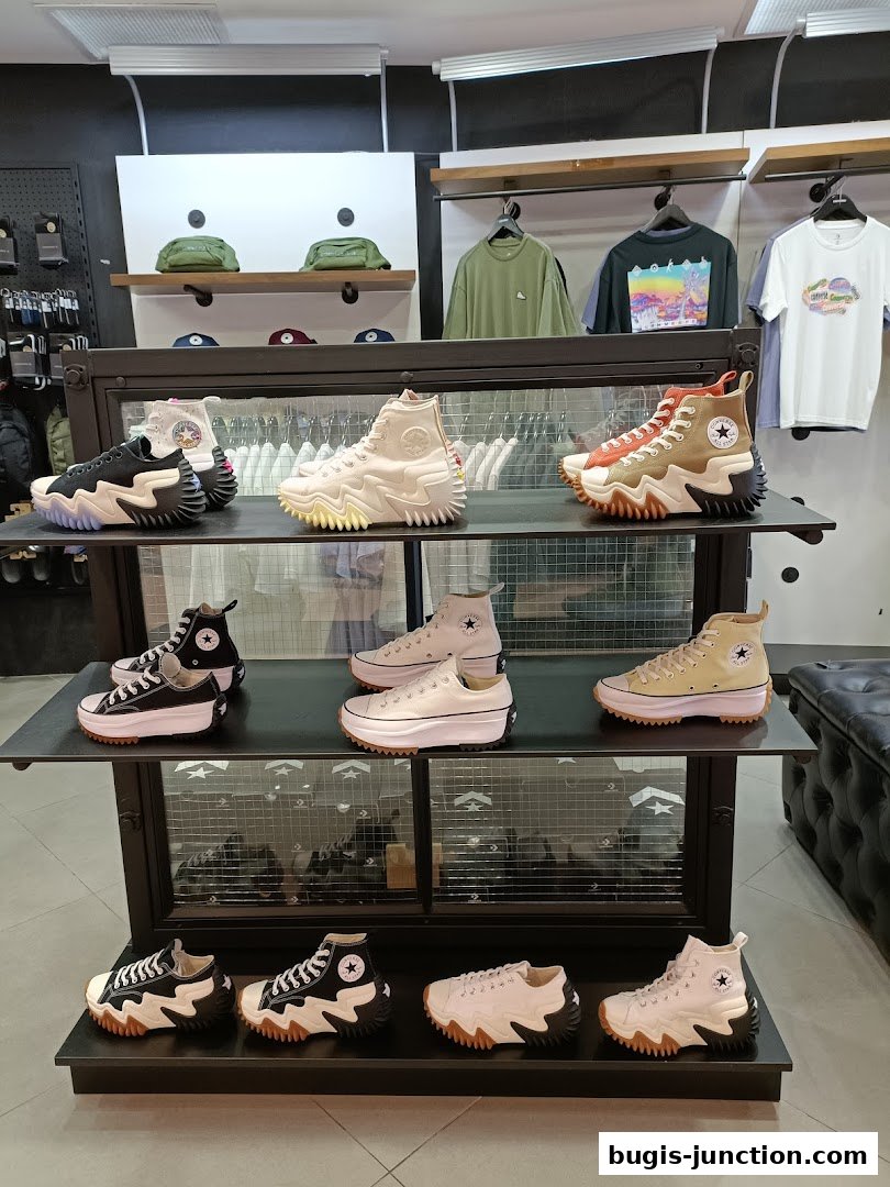 A display of Converse shoes and apparel inside a retail store.