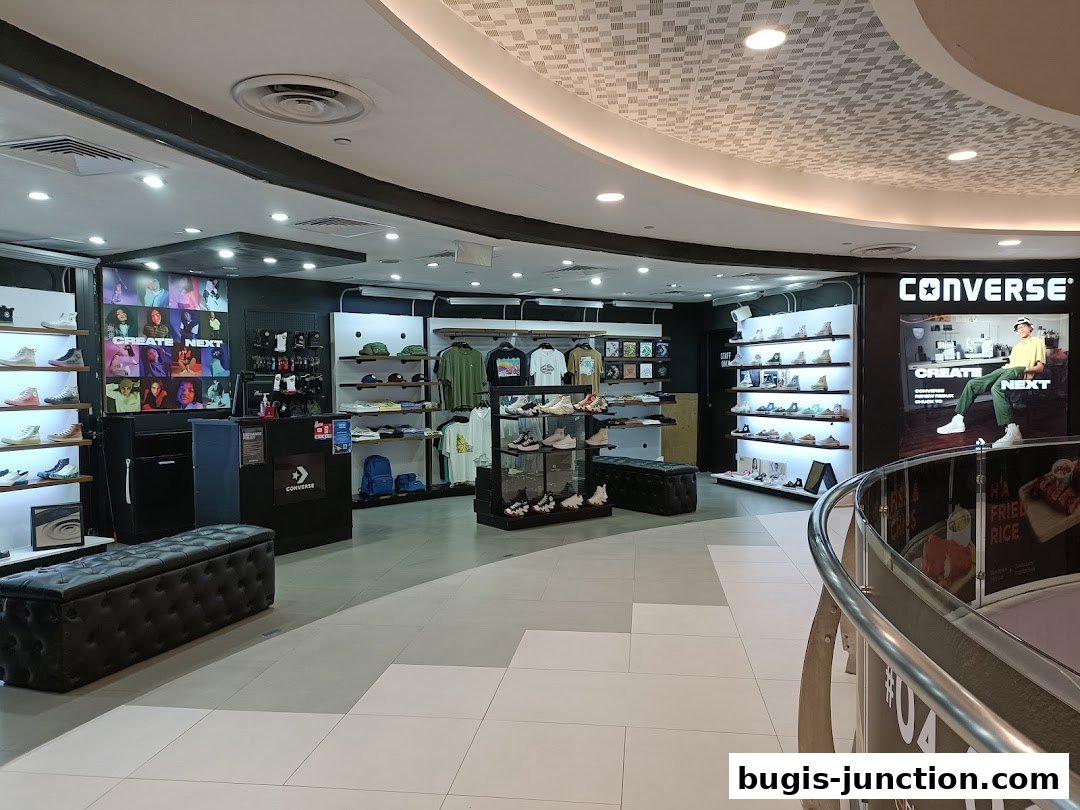 Interior view of a Converse store showcasing shoes, apparel, and accessories.