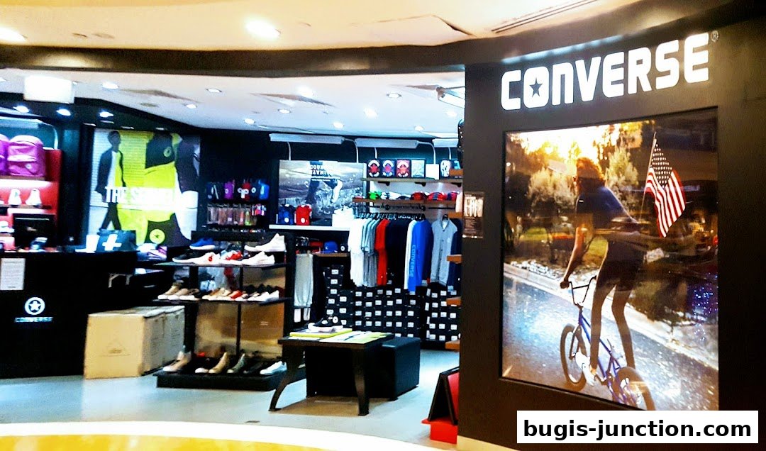 Interior view of a Converse store showcasing shoes, apparel, and accessories.