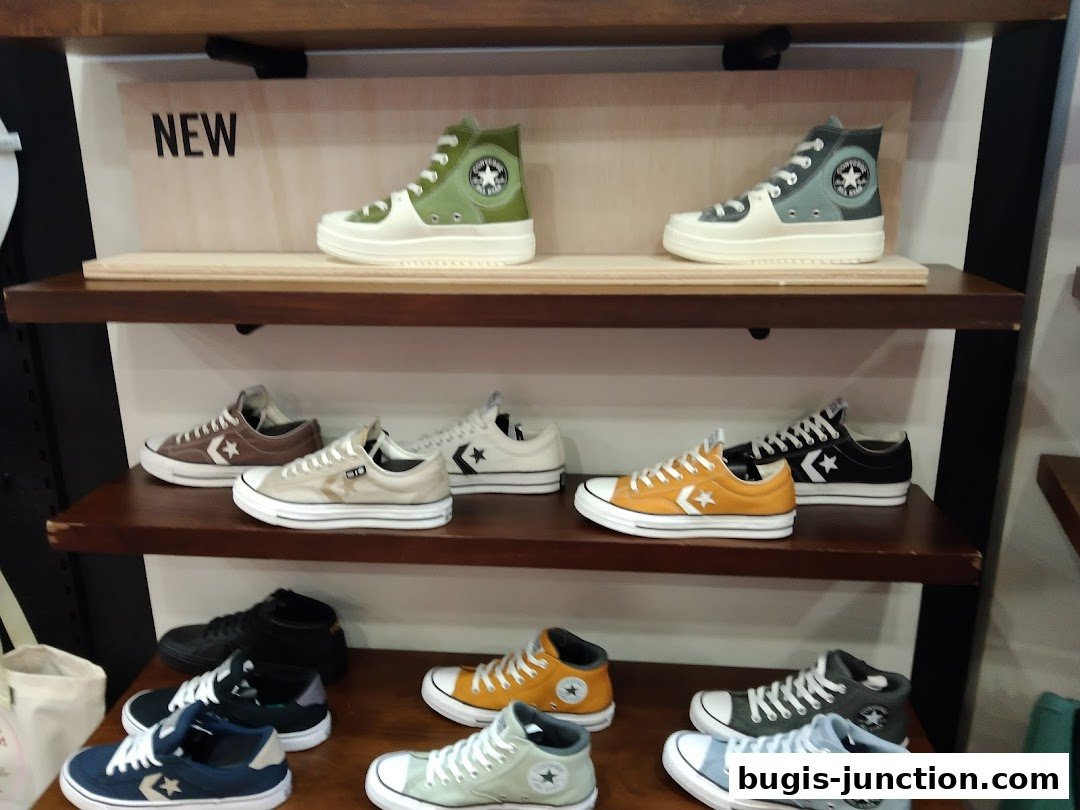 A display of various Converse sneakers on shelves, featuring new arrivals and different colorways.