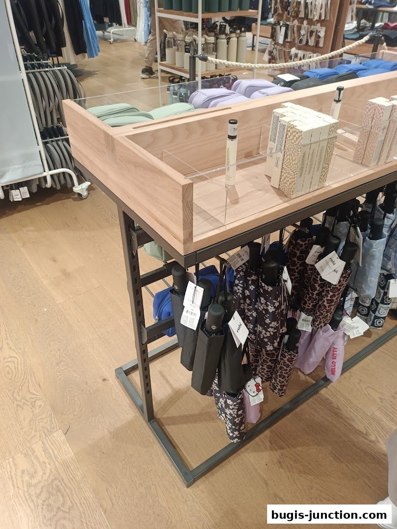 Display of umbrellas and other accessories in a retail store.