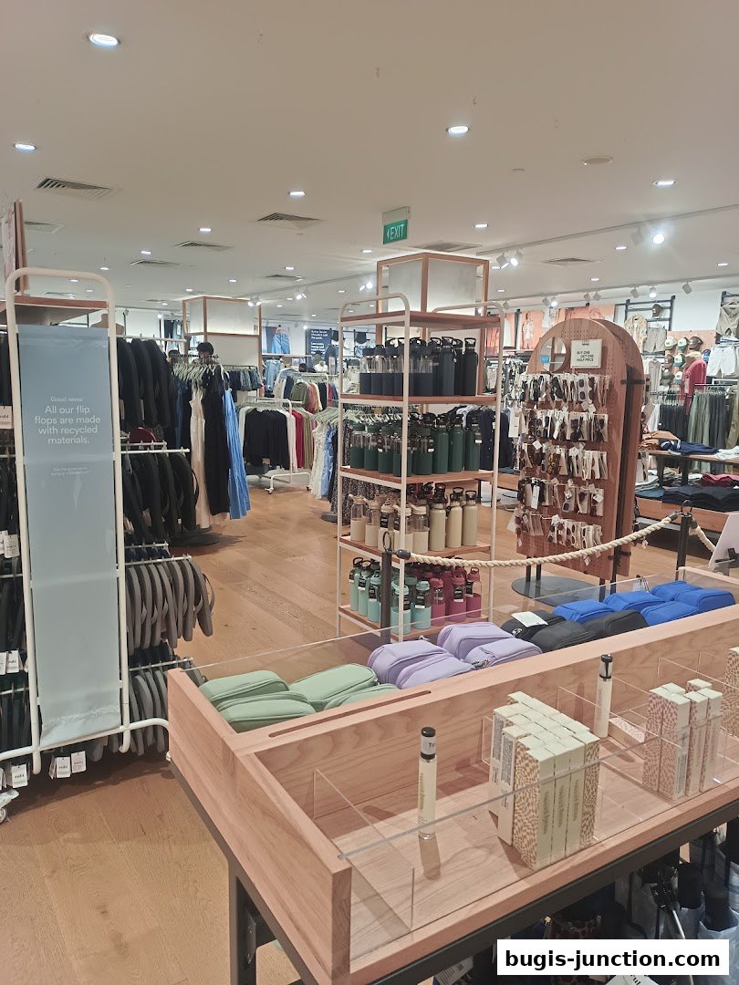 Interior view of a Cotton On and Rubi store showcasing apparel, accessories, and water bottles.