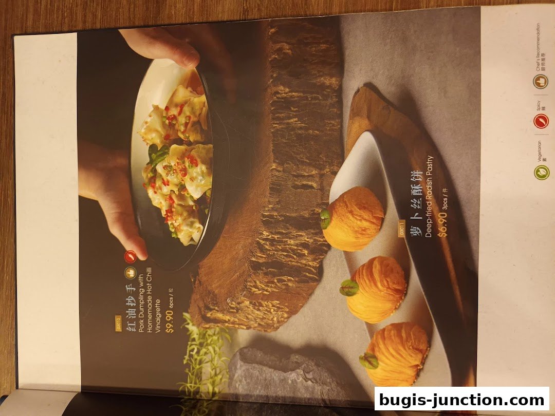 A menu page showcasing two signature dishes from Crystal Jade La Mian Xiao Long Bao.