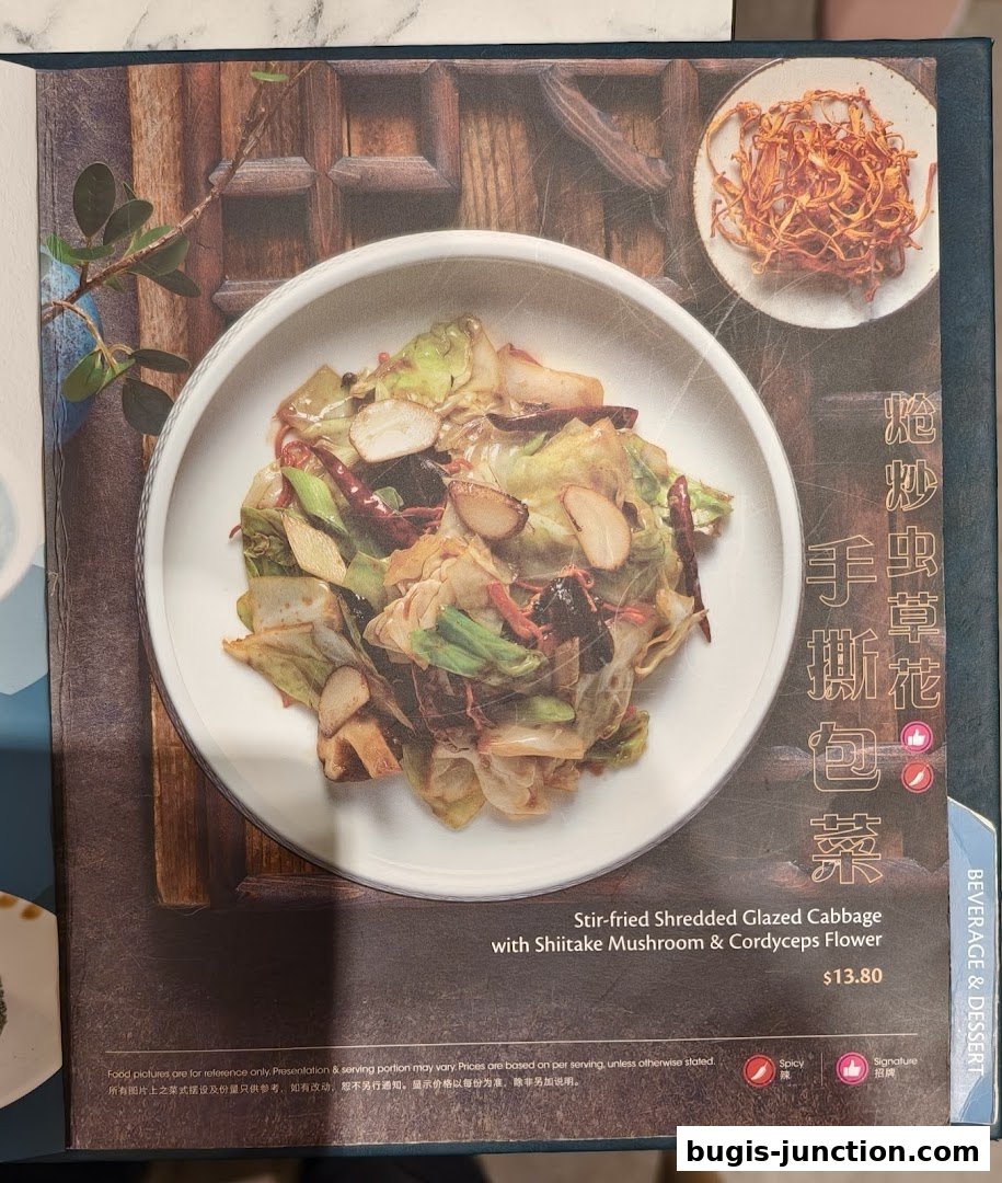 A menu page featuring a dish of stir-fried shredded glazed cabbage with mushrooms and cordyceps flower.