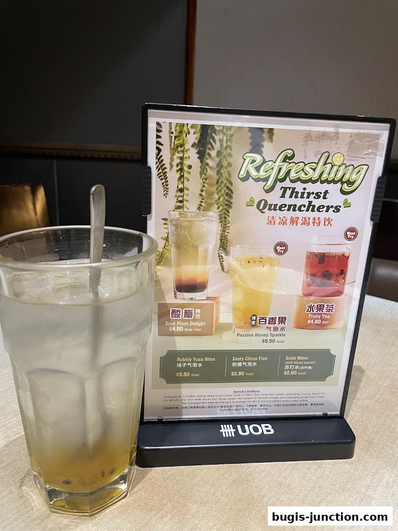 A menu stand displaying refreshing thirst quenchers with images and prices.