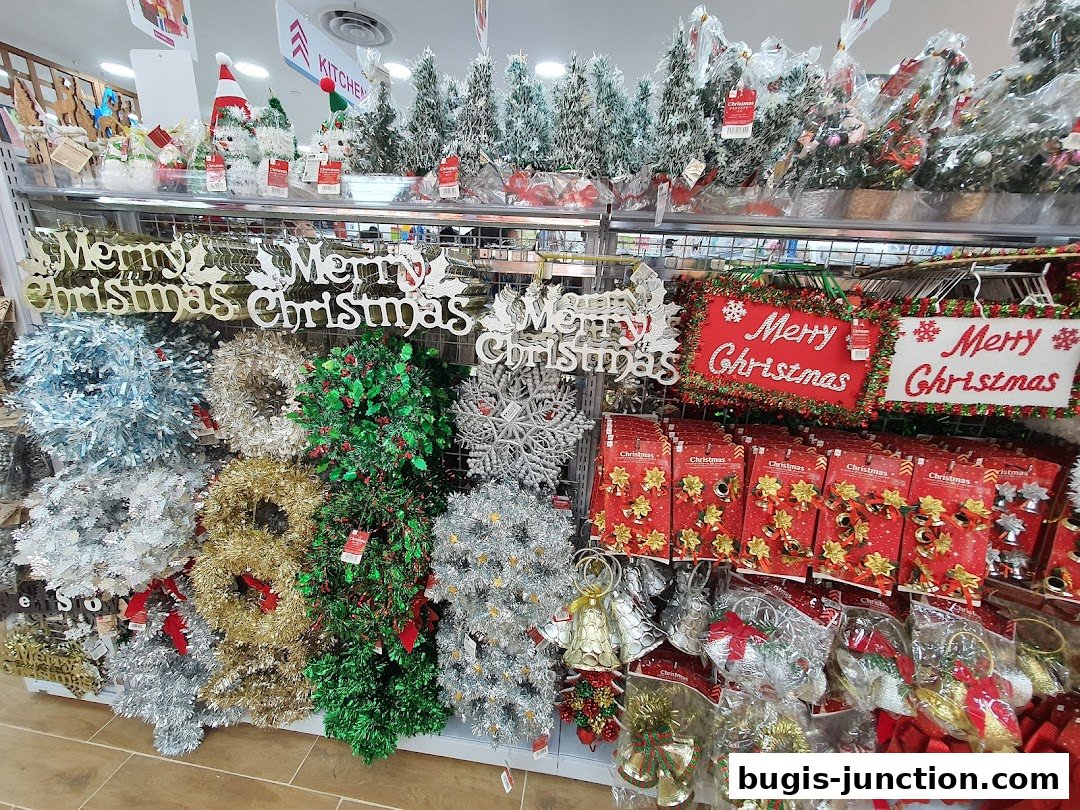 A wide selection of Christmas decorations, including wreaths, garlands, and festive signs.