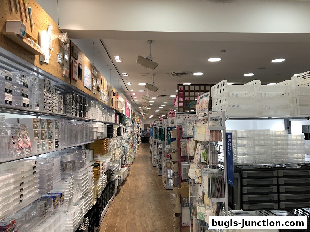A long aisle of shelves filled with various storage containers and household items in a Daiso store.