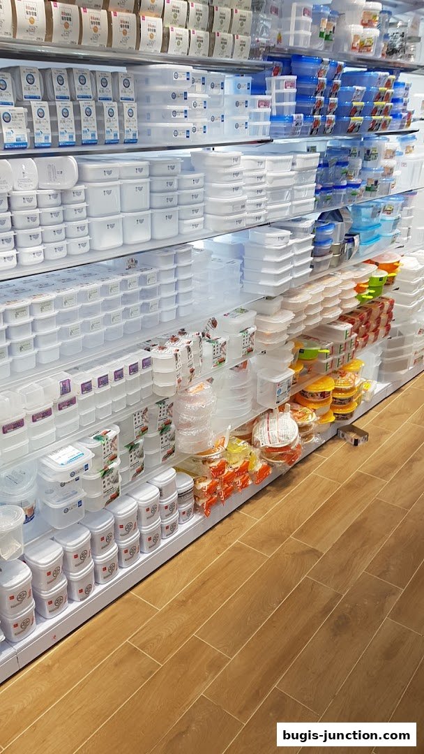 A wide selection of food storage containers and kitchenware displayed on shelves.
