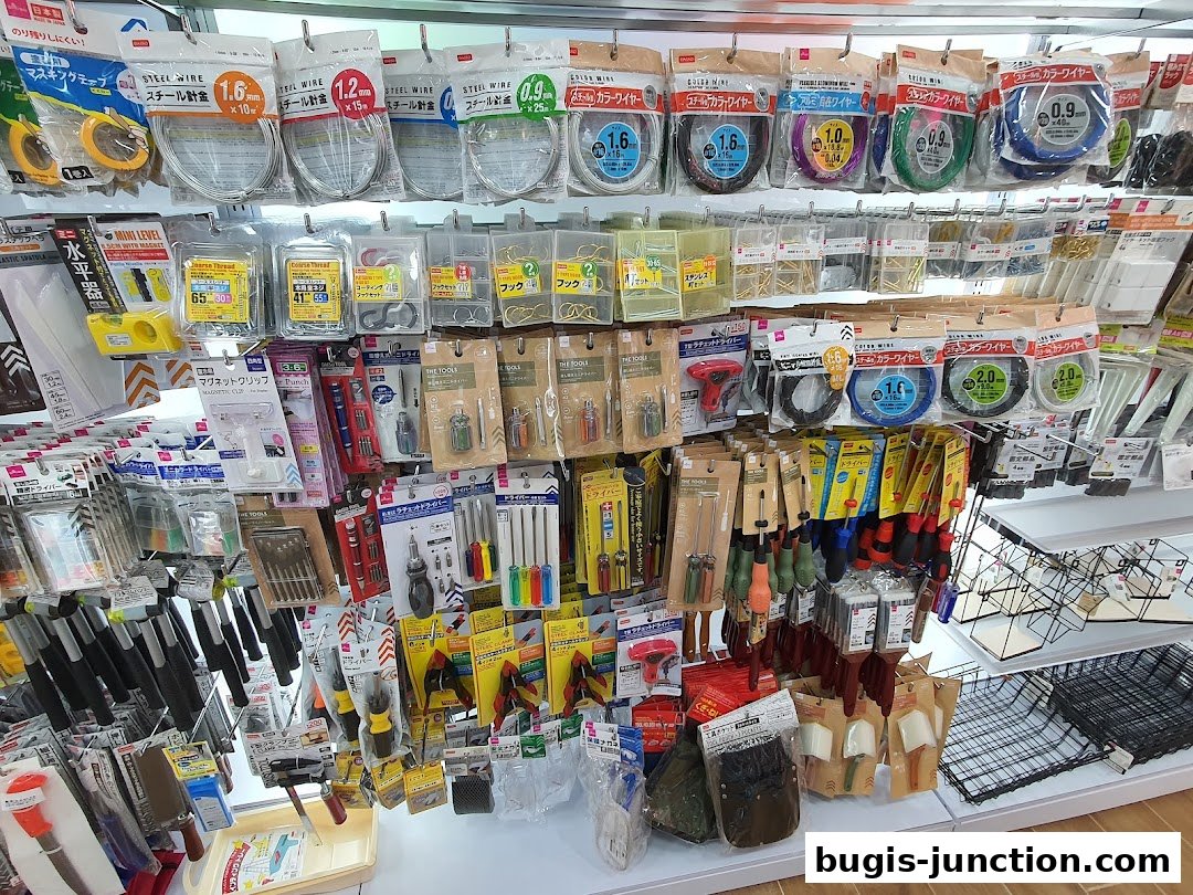 Shelves stocked with various hardware items like wires, tools, and fasteners.