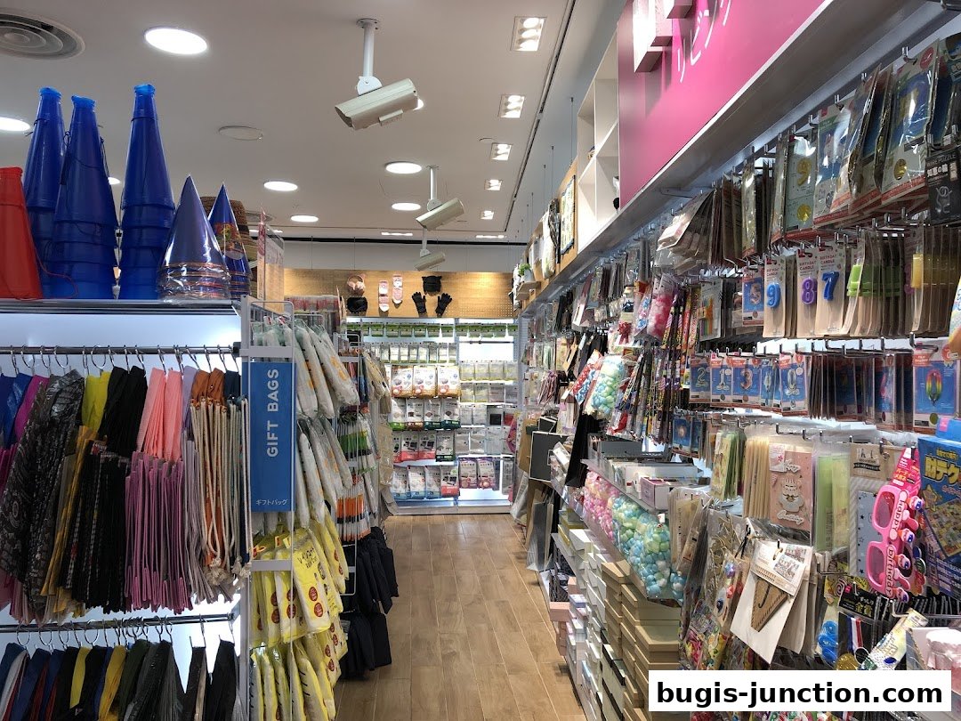Interior view of a Daiso store showcasing a wide variety of party supplies and gift bags.
