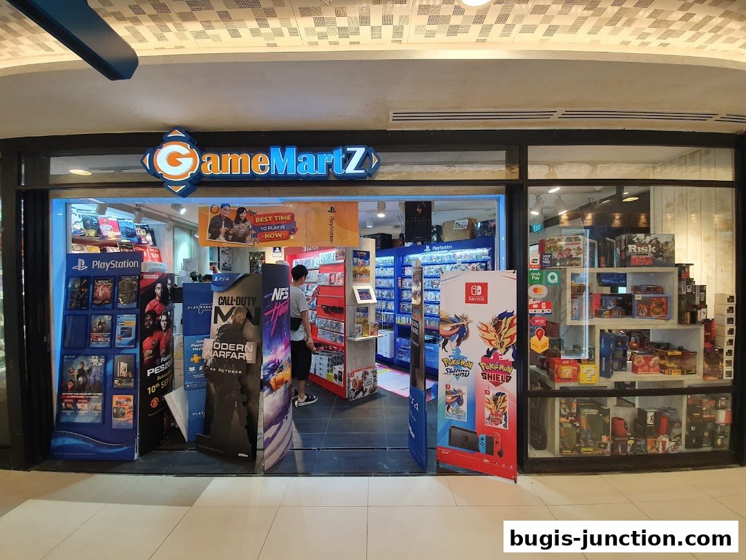 The entrance of GameMartZ, a video game store, displaying various game titles and consoles.