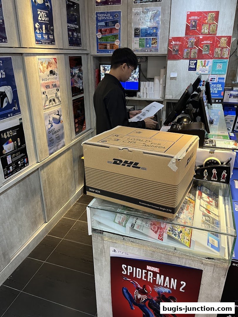 A store employee is processing a DHL package at a counter with gaming merchandise and promotions displayed.