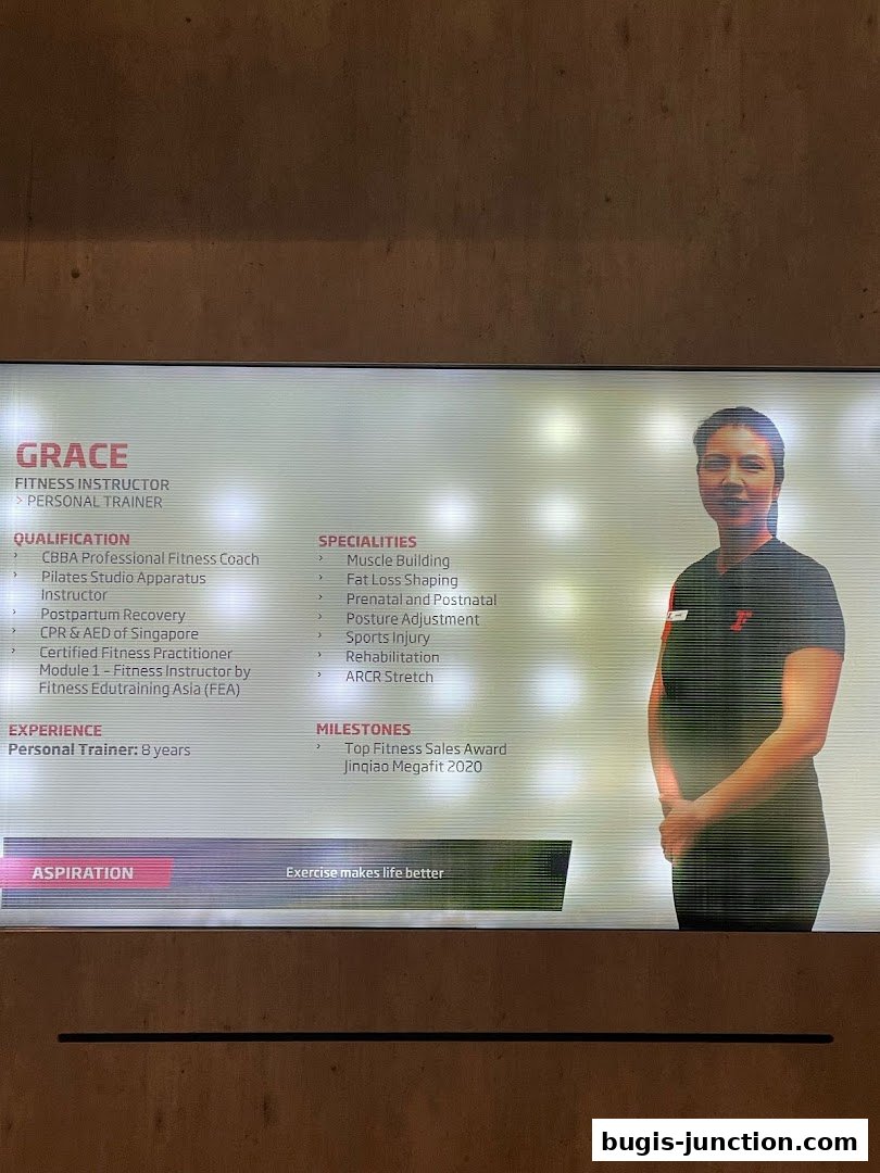 A digital display showcasing a Fitness Instructor named Grace, detailing her qualifications and specialities.