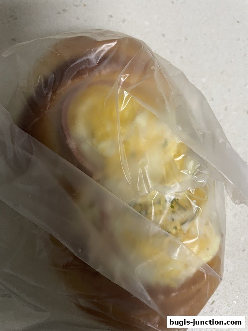 A close-up of a baked good, possibly a pastry or bread, in a clear plastic bag.