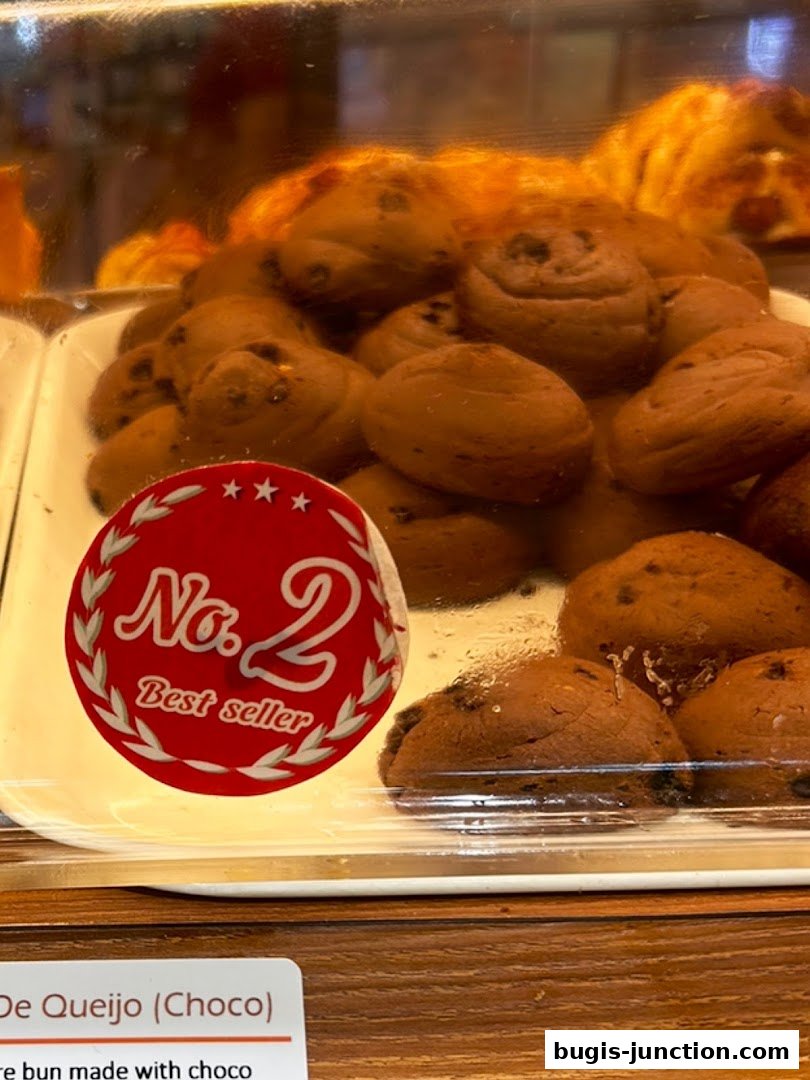 A display of chocolate chip buns labeled as a best seller at Four Leaves bakery.
