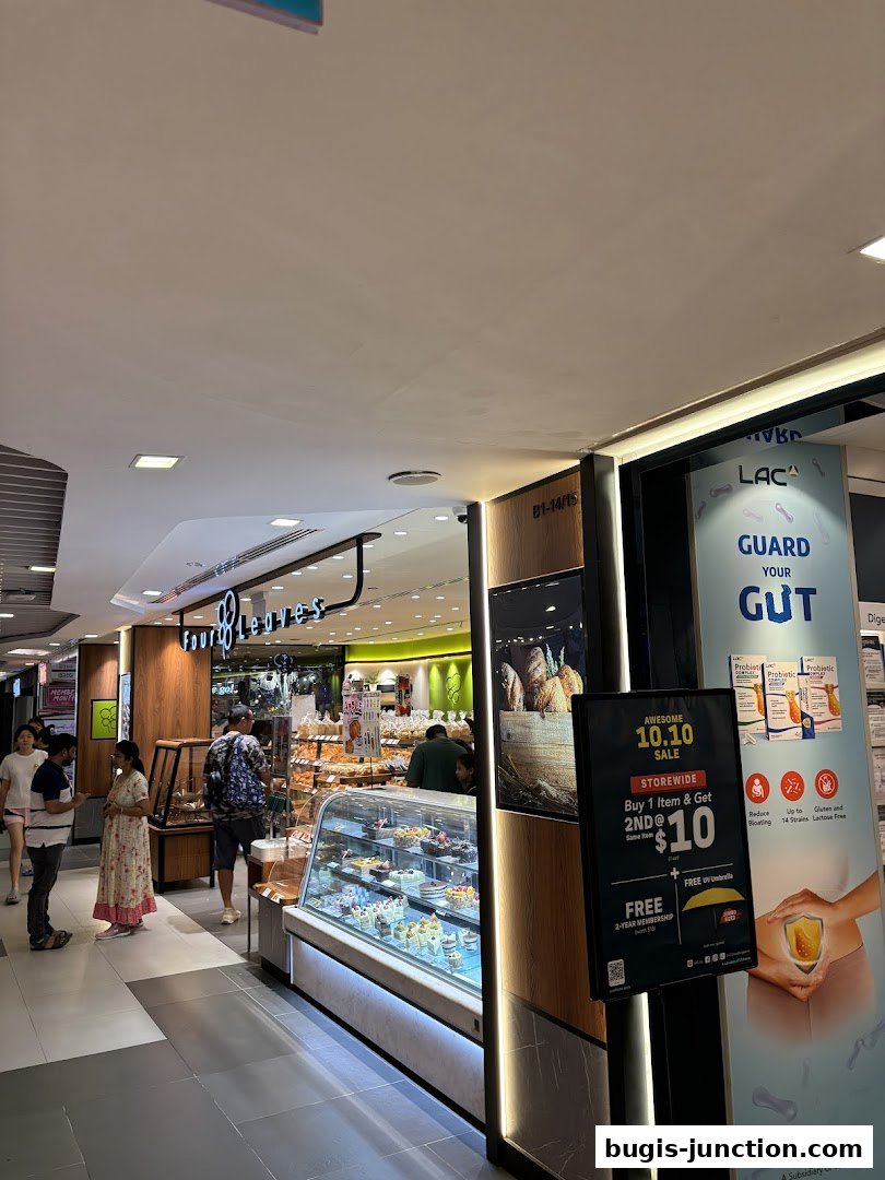 A bakery shop called Four Leaves with a display of cakes and pastries, and a sale promotion.