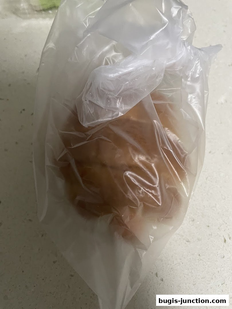 A close-up shot of a pastry in a clear plastic bag.