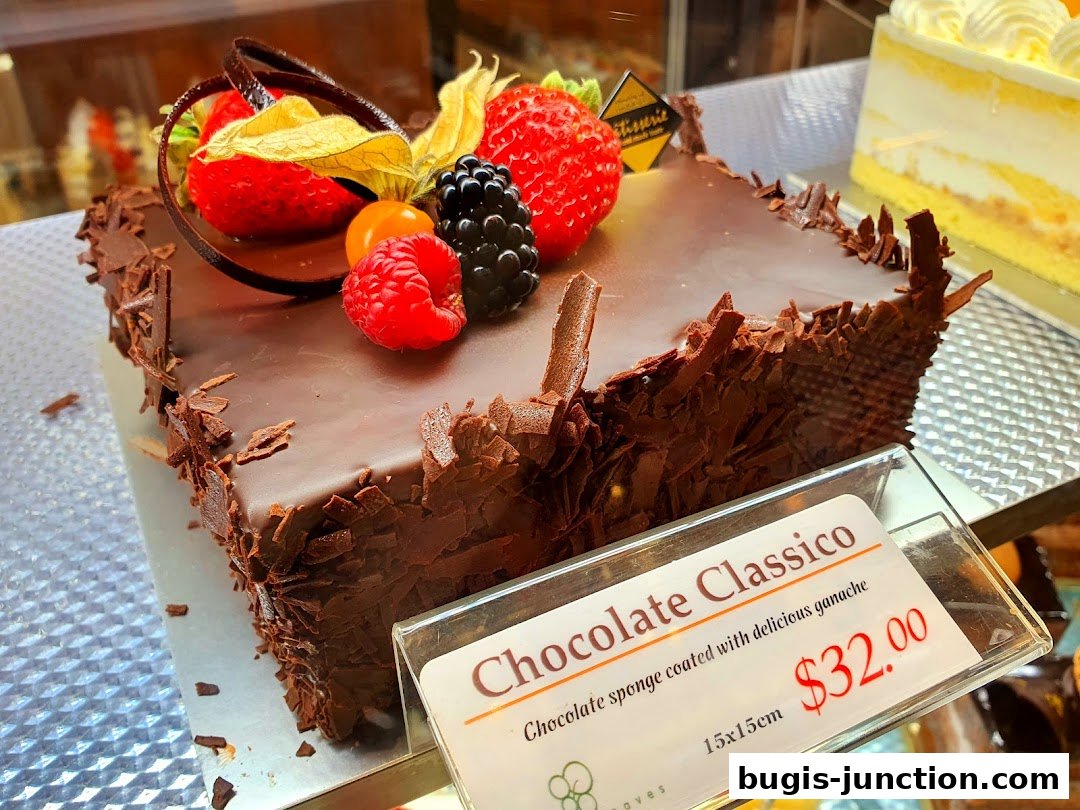 A decadent chocolate cake topped with fresh berries and chocolate shavings.