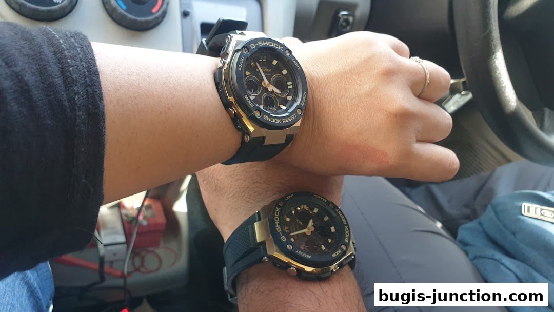 Two people wearing G-SHOCK watches with gold accents and black straps.