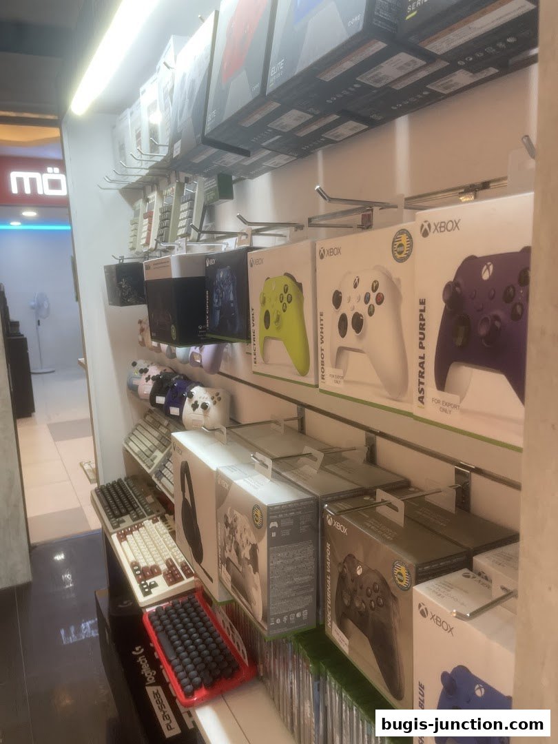 A retail store display featuring various gaming accessories, including controllers and keyboards.