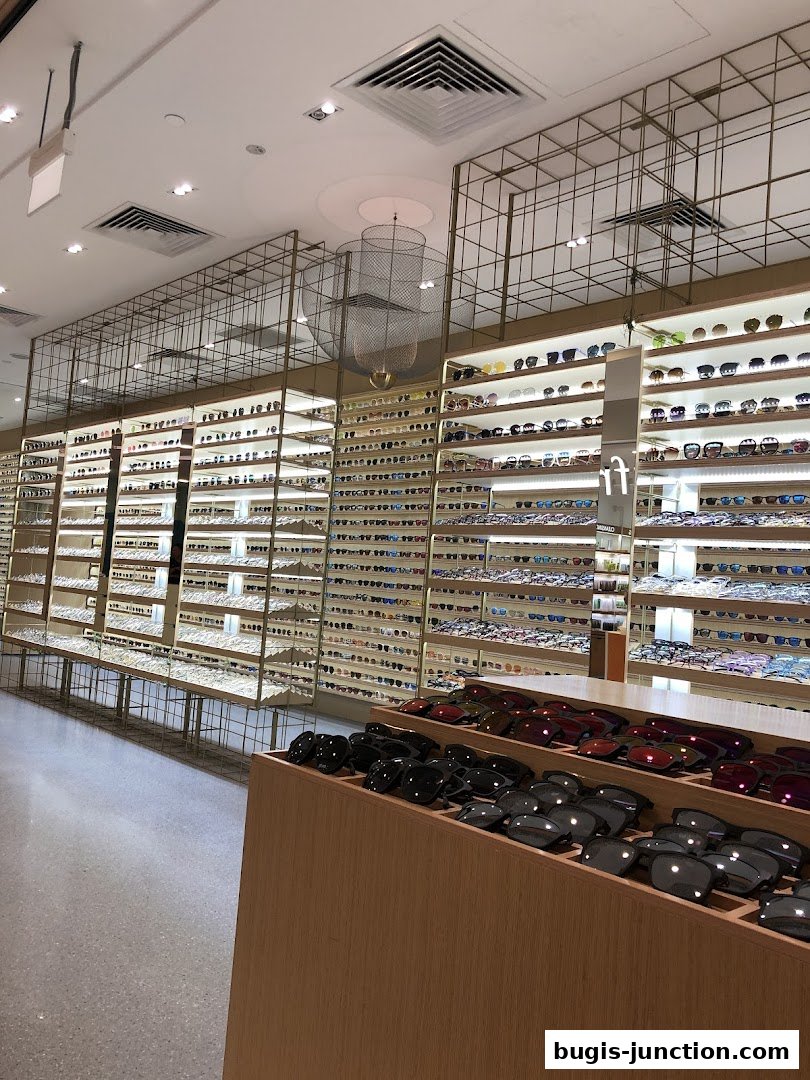 Interior view of a modern eyewear store showcasing a vast collection of sunglasses and eyeglasses.