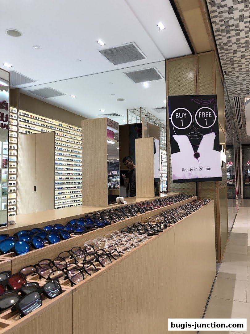 A shop displaying a wide variety of eyeglasses and sunglasses on wooden shelves.