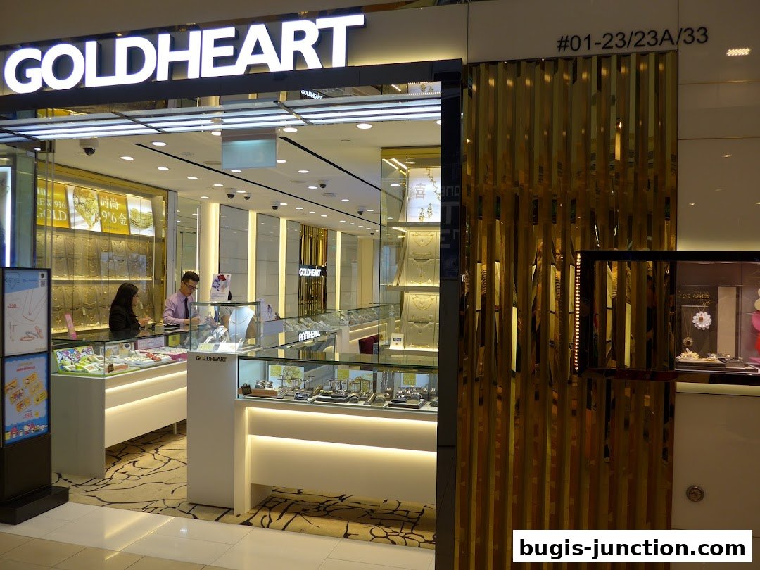 The Goldheart Jewelry store features a bright, modern interior with displays of gold jewelry and attentive staff.