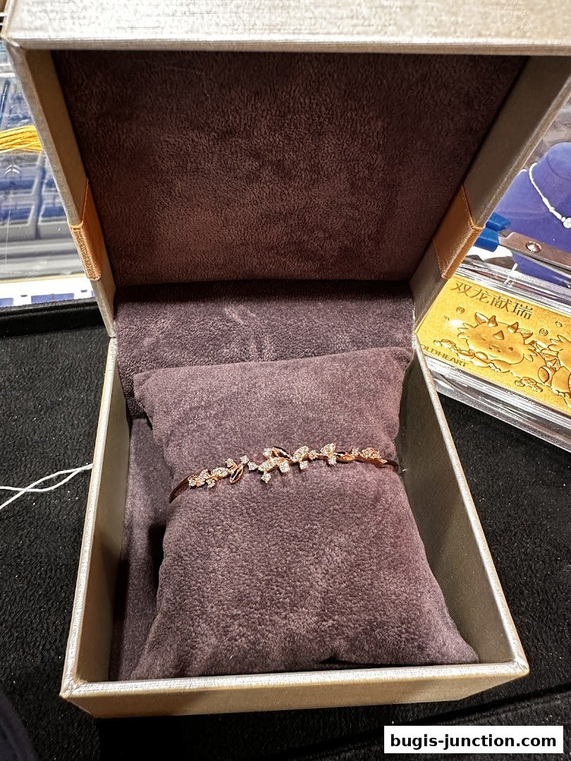 A delicate rose gold bracelet with diamond accents displayed in an open jewelry box.