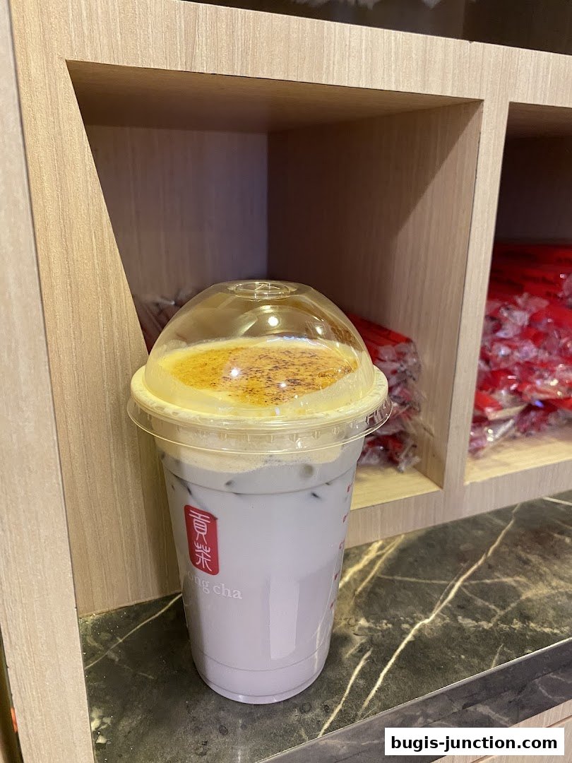 A close-up of a purple drink with a creamy top and caramelized sugar.