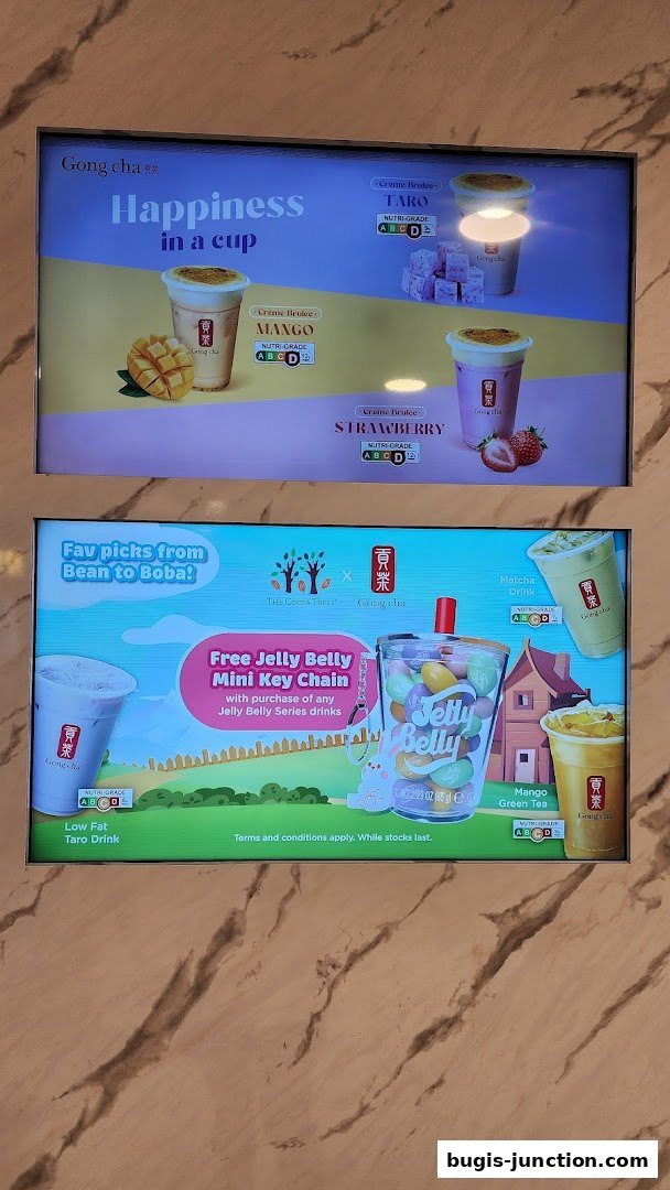 Digital menu displays showcasing Gong Cha drinks and a special promotion.