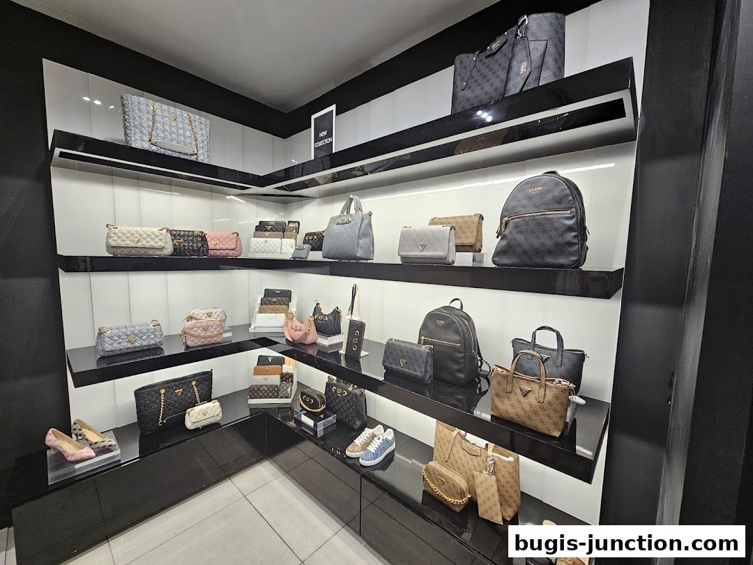 A display of various Guess handbags, wallets, and shoes on shelves in a store.