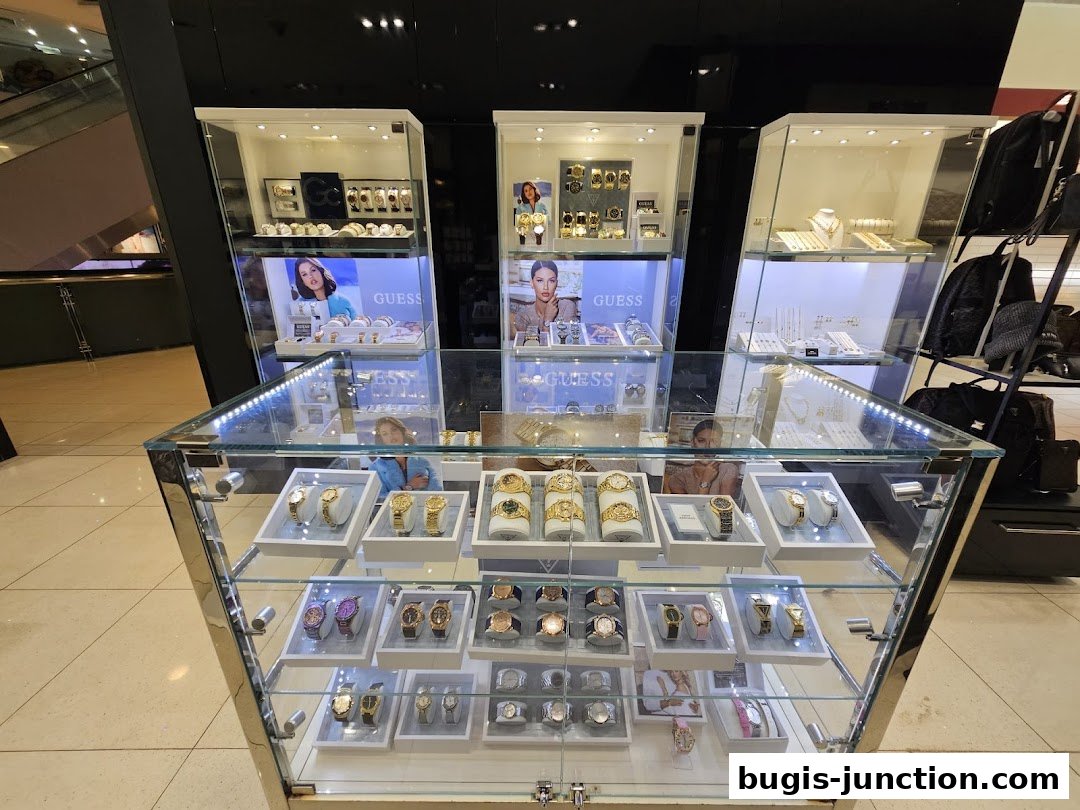 A display of Guess watches and accessories in illuminated glass cabinets.